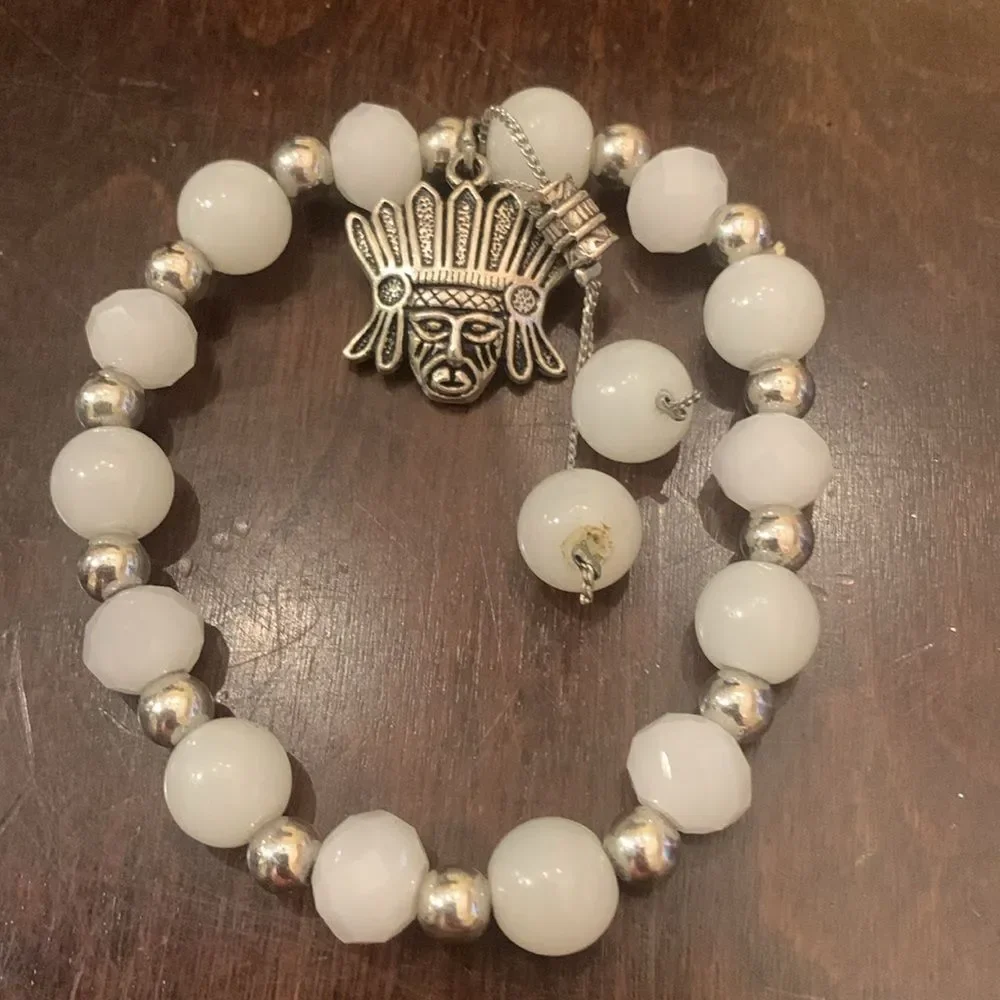 White and silver bracelet with Mayan charm